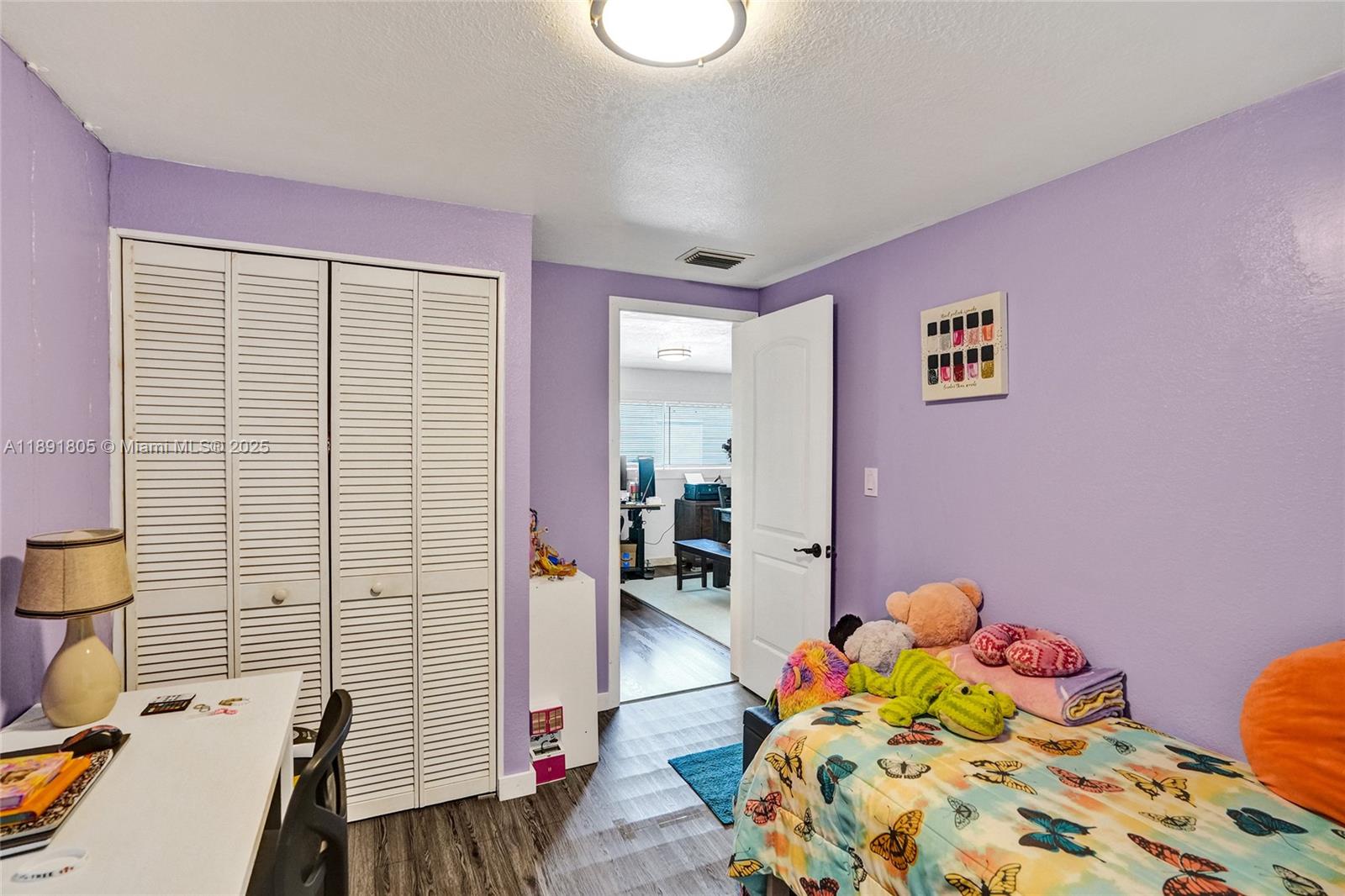 11201 Southwest 55th Street Miramar, FL 33025 - Photo 23 of 38 a bedroom with a bed and wooden floor