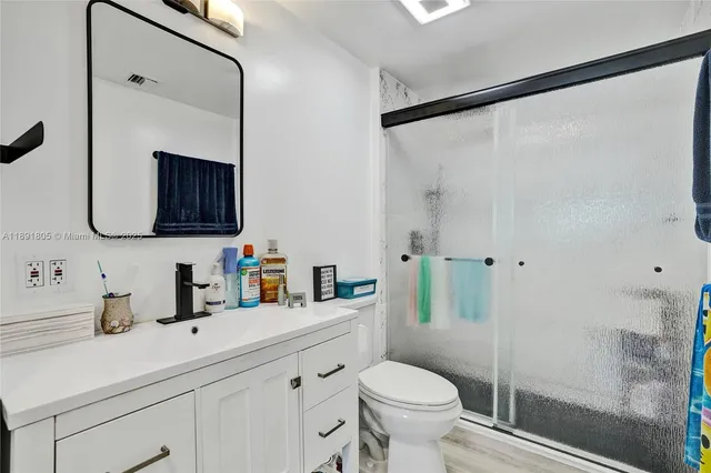a bathroom with a sink toilet and shower