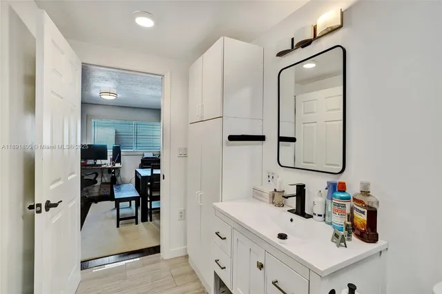 a bathroom with a sink vanity and a mirror