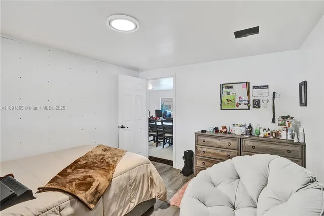 a bedroom with a bed and a dresser