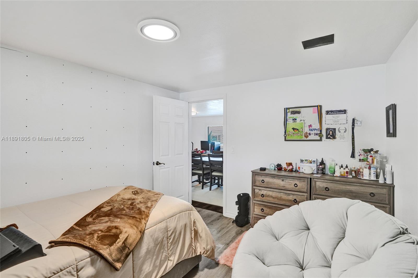 11201 Southwest 55th Street Miramar, FL 33025 - Photo 28 of 38 a bedroom with a bed and a dresser