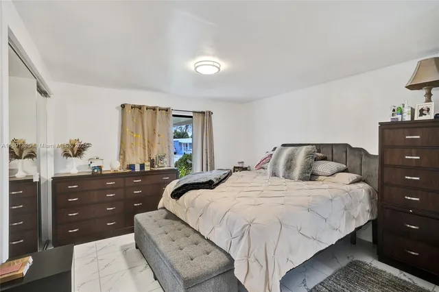 a bedroom with a bed and a dresser