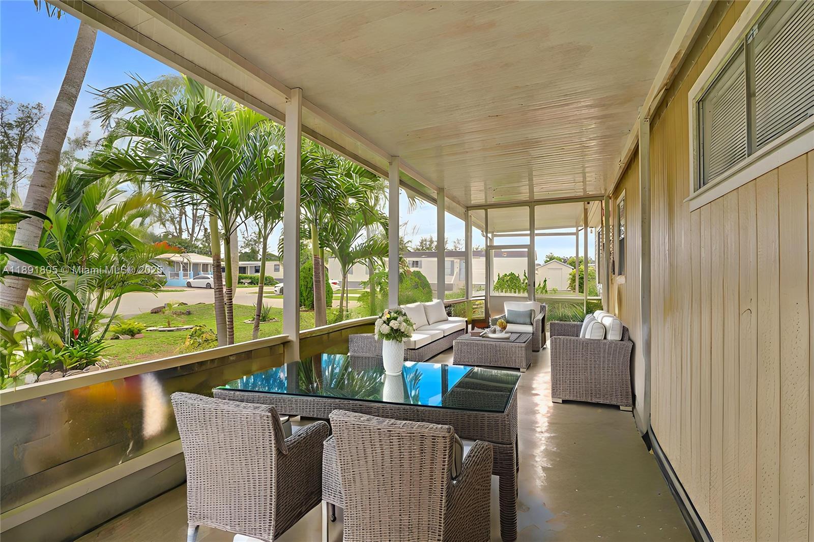 11201 Southwest 55th Street Miramar, FL 33025 - Photo 3 of 38 a dining room with furniture and a floor to ceiling window