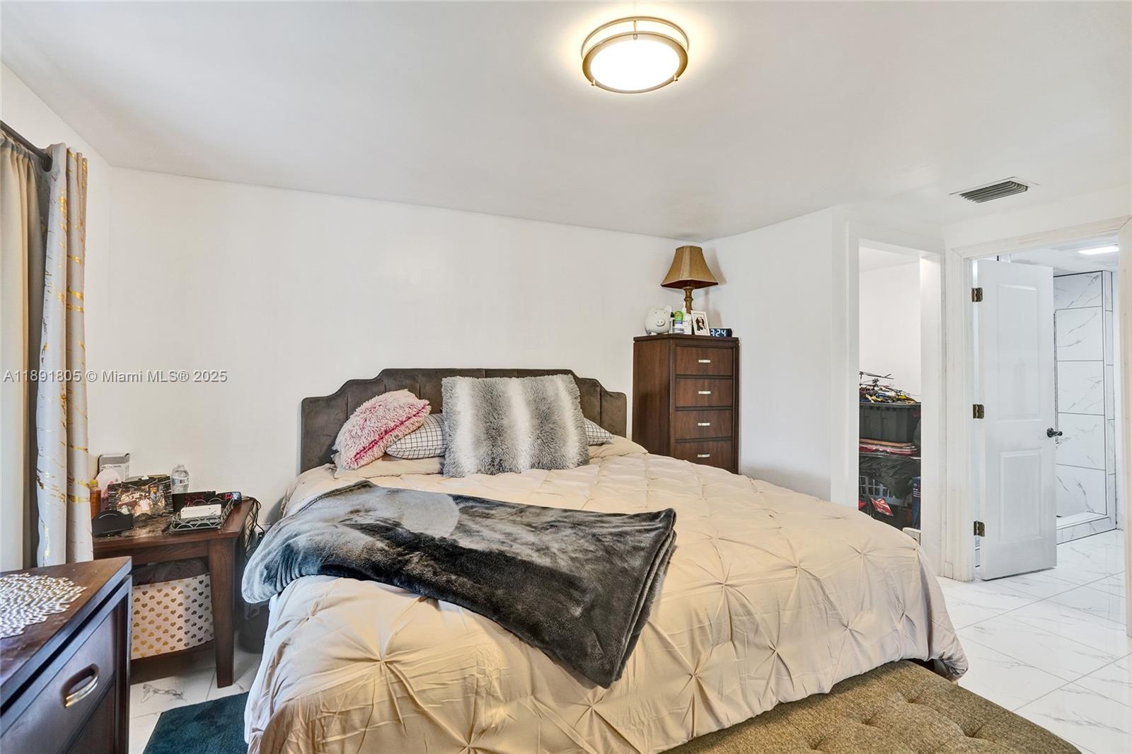 11201 Southwest 55th Street Miramar, FL 33025 - Photo 32 of 38 a bedroom with a bed and wooden floor