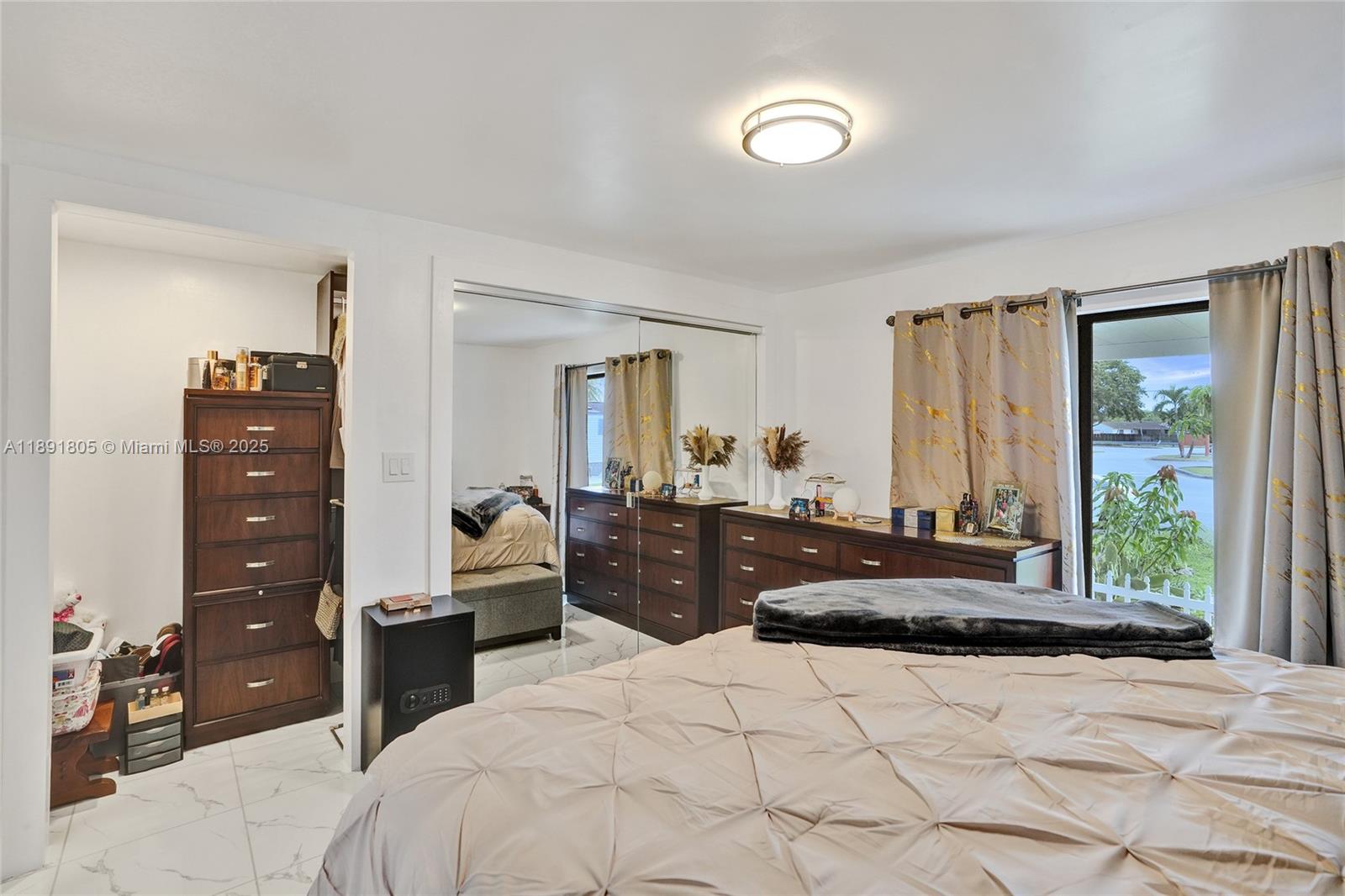 11201 Southwest 55th Street Miramar, FL 33025 - Photo 33 of 38 a bedroom with a bed and a large mirror