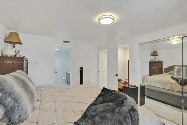 a bedroom with a bed and a lamp