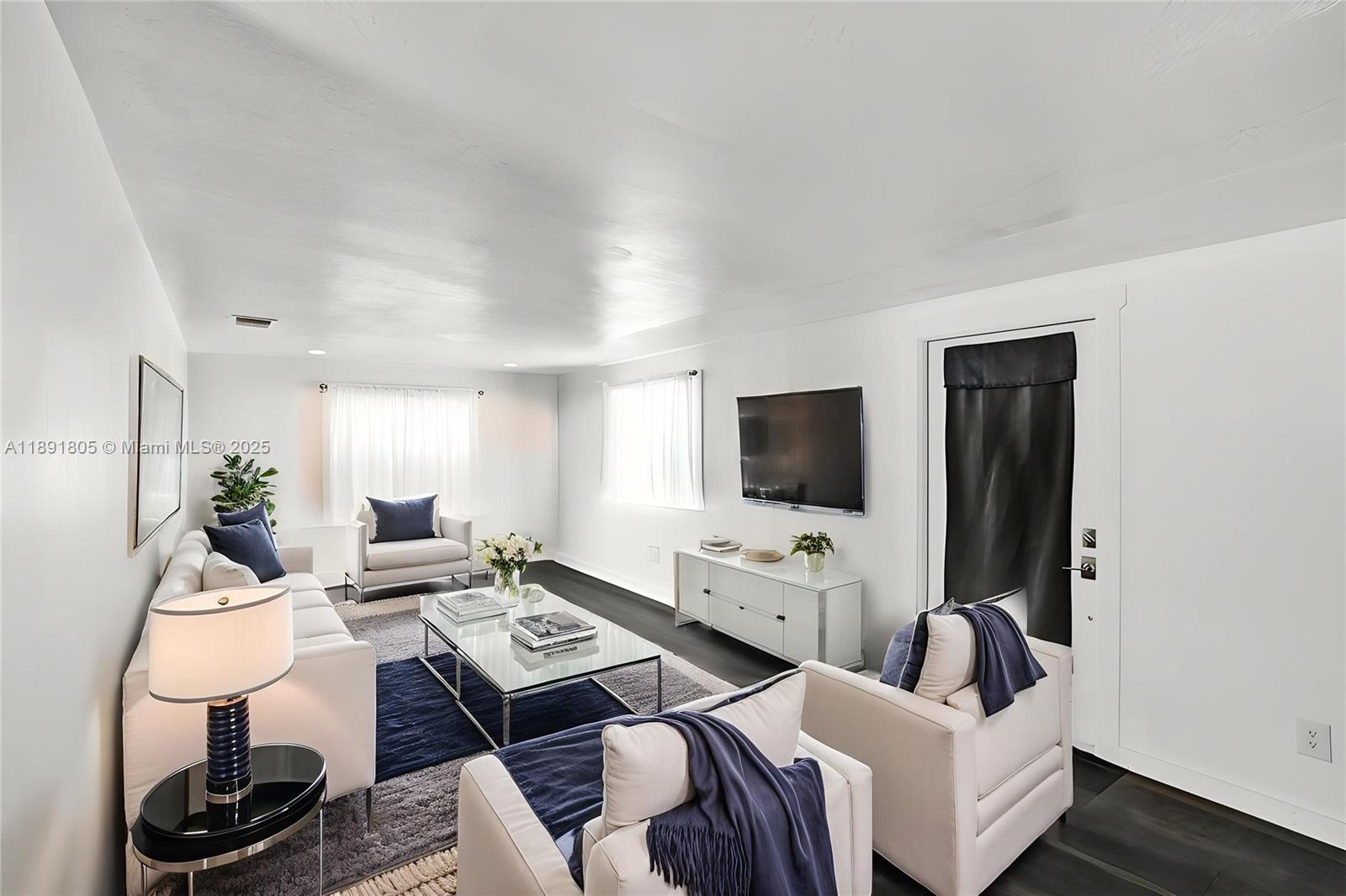 11201 Southwest 55th Street Miramar, FL 33025 - Photo 6 of 38 a living room with furniture a flat screen tv and a window