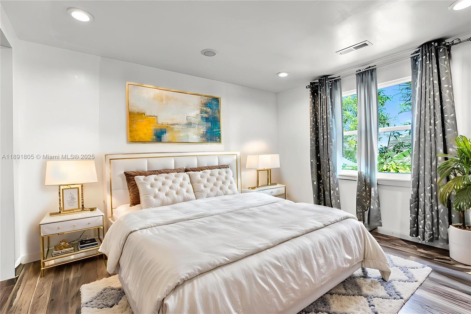 11201 Southwest 55th Street Miramar, FL 33025 - Photo 7 of 38 a bedroom with a bed and wooden floor