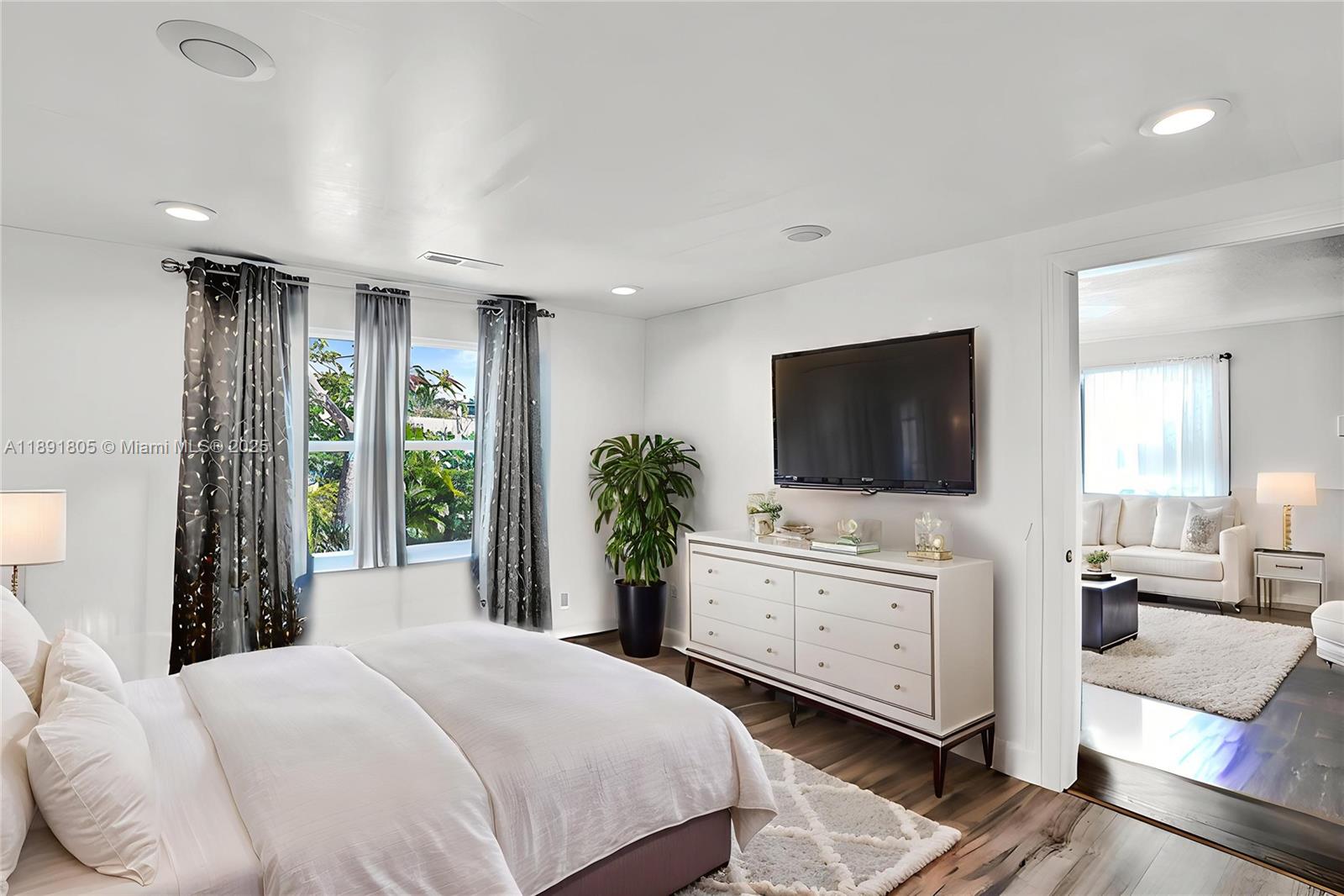 11201 Southwest 55th Street Miramar, FL 33025 - Photo 9 of 38 a bedroom with a large bed and a flat screen tv