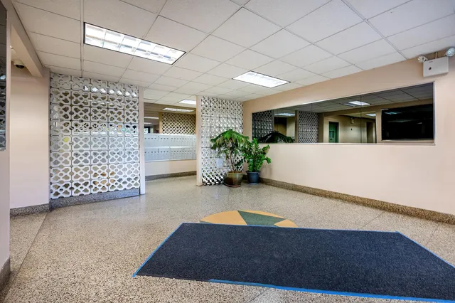 a bathroom with a sink a toilet a mirror and shower curtain