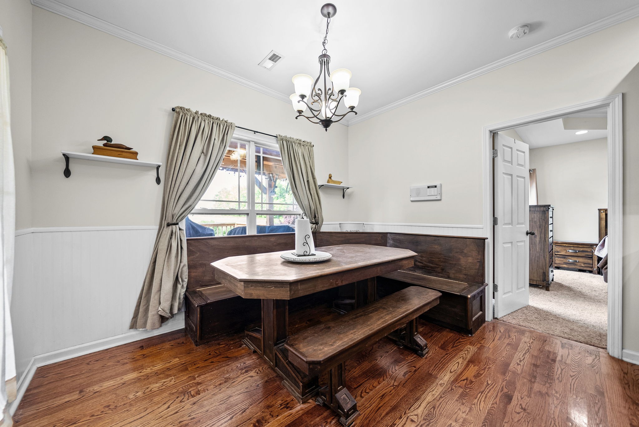 195 Barkers Mill Road Pembroke, KY 42266 - Photo 12 of 39 a dining room with wooden floor a chandelier a wooden table and chairs