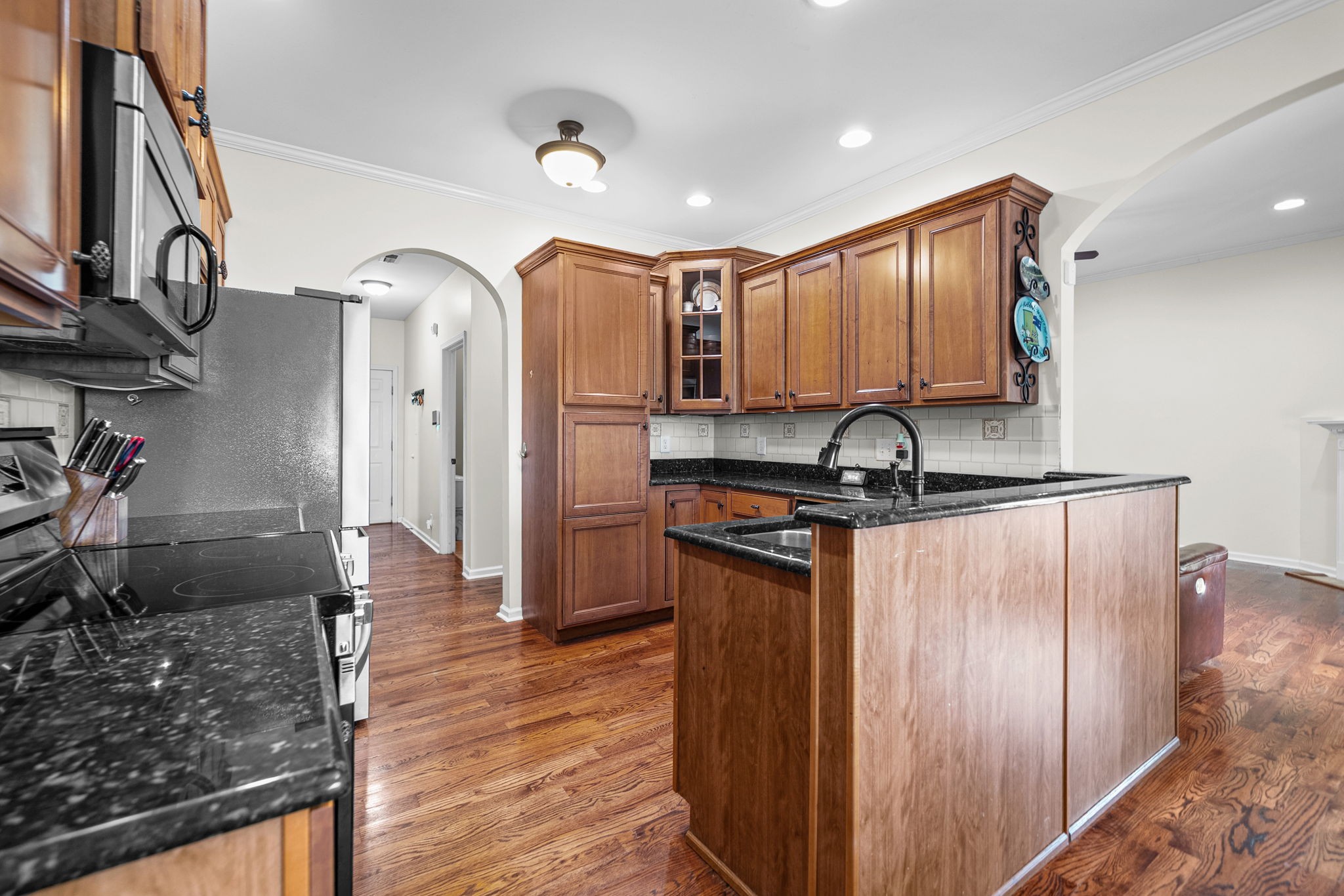 195 Barkers Mill Road Pembroke, KY 42266 - Photo 8 of 39 a kitchen with stainless steel appliances granite countertop a refrigerator a sink and wooden cabinets