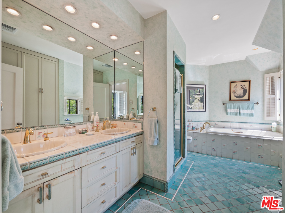 810 Devon Avenue Los Angeles, CA 90024 - Photo 13 of 23 a spacious bathroom with a granite countertop sink mirror and a