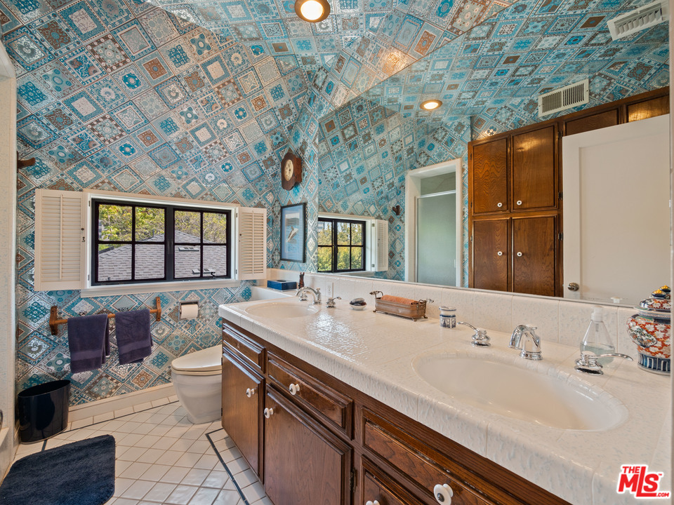 810 Devon Avenue Los Angeles, CA 90024 - Photo 15 of 23 a bathroom with a sink and a large mirror