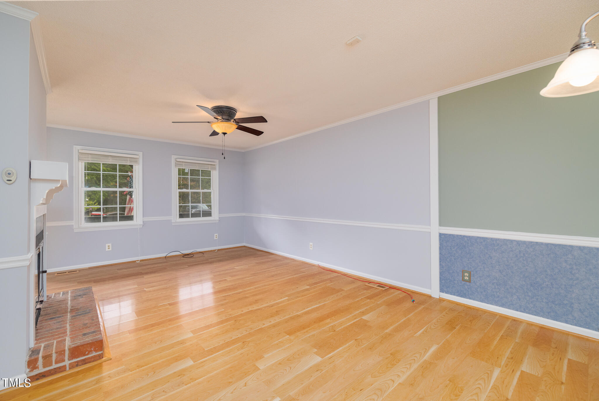 110 Lake Road Henderson, NC 27537 - Photo 7 of 36 a view of an empty room with wooden floor and a window