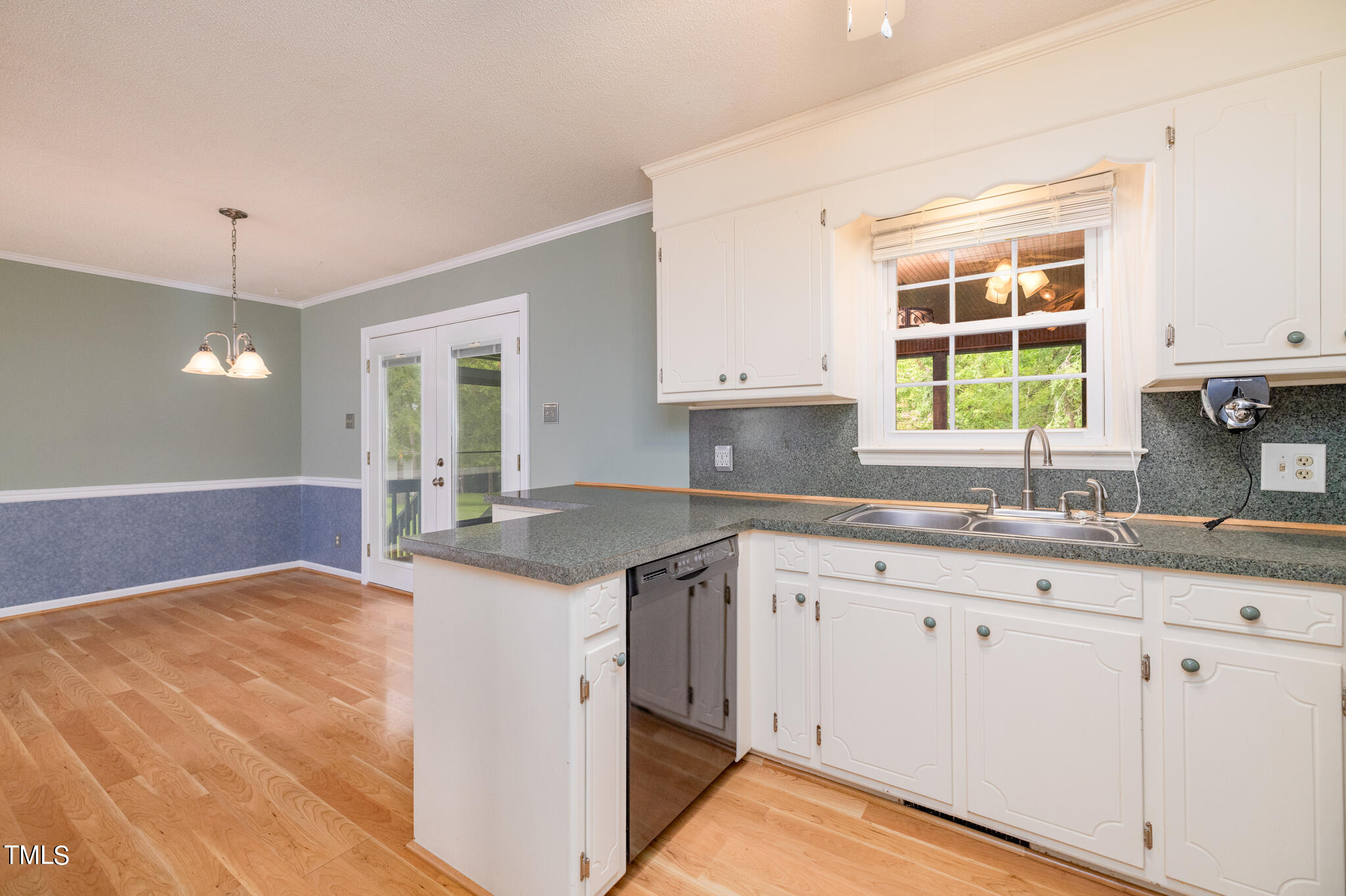 110 Lake Road Henderson, NC 27537 - Photo 10 of 36 a kitchen with granite countertop a sink window and cabinets