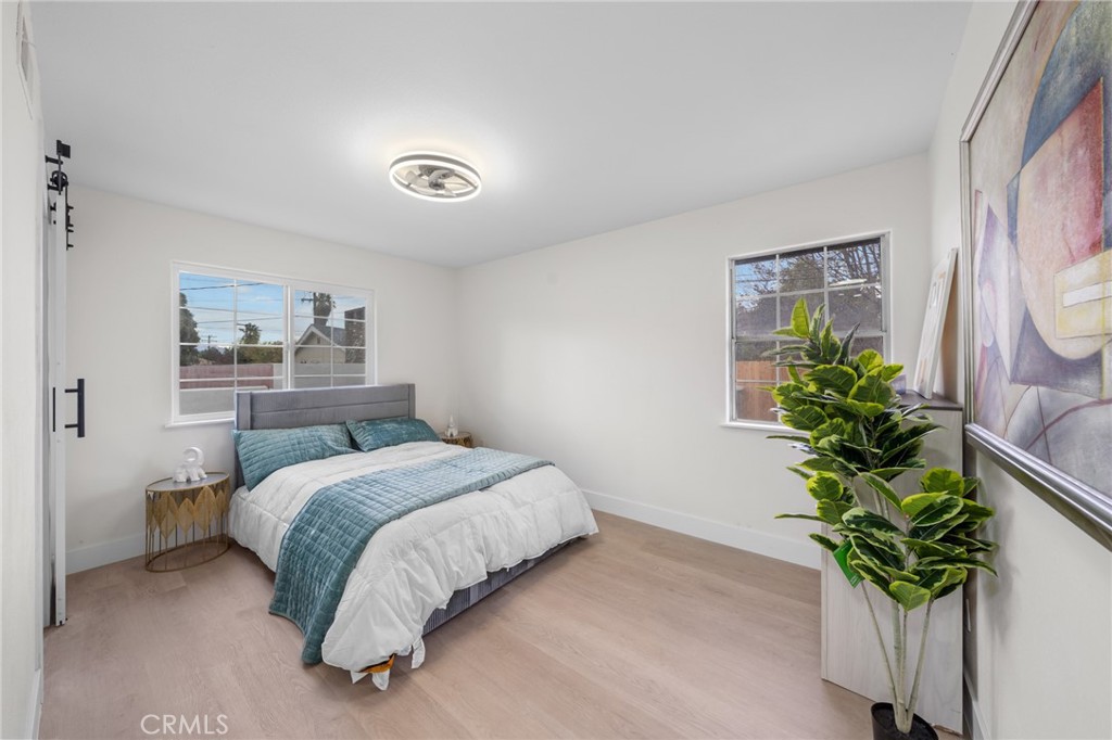 2717 West 6th Street Rialto, CA 92376 - Photo 13 of 30 a bedroom with a bed and a potted plant