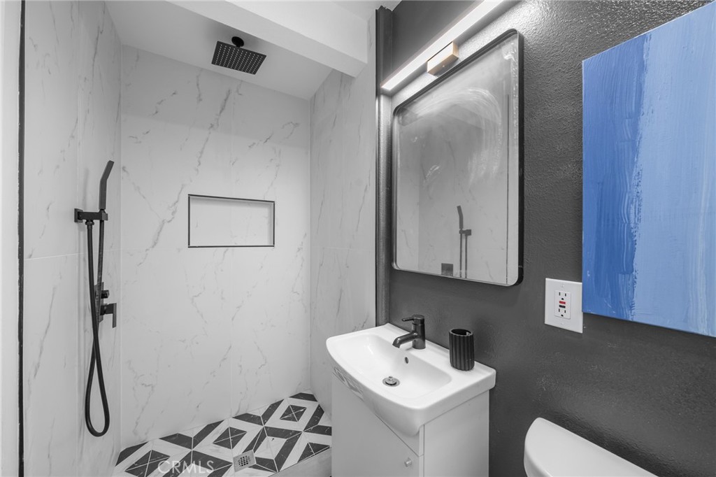 2717 West 6th Street Rialto, CA 92376 - Photo 15 of 30 a bathroom with a sink toilet and mirror