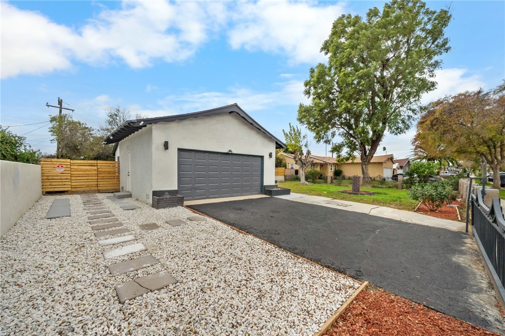 2717 West 6th Street Rialto, CA 92376 - Photo 2 of 30 a front view of a house with a yard and garage