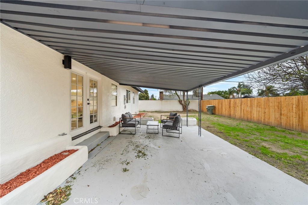 2717 West 6th Street Rialto, CA 92376 - Photo 26 of 30 a view of backyard with table and chairs and wooden fence