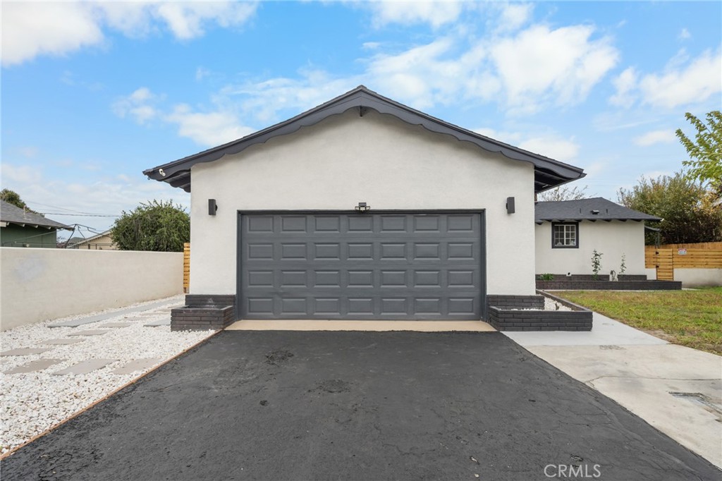 2717 West 6th Street Rialto, CA 92376 - Photo 29 of 30 a front view of a house with a yard and garage