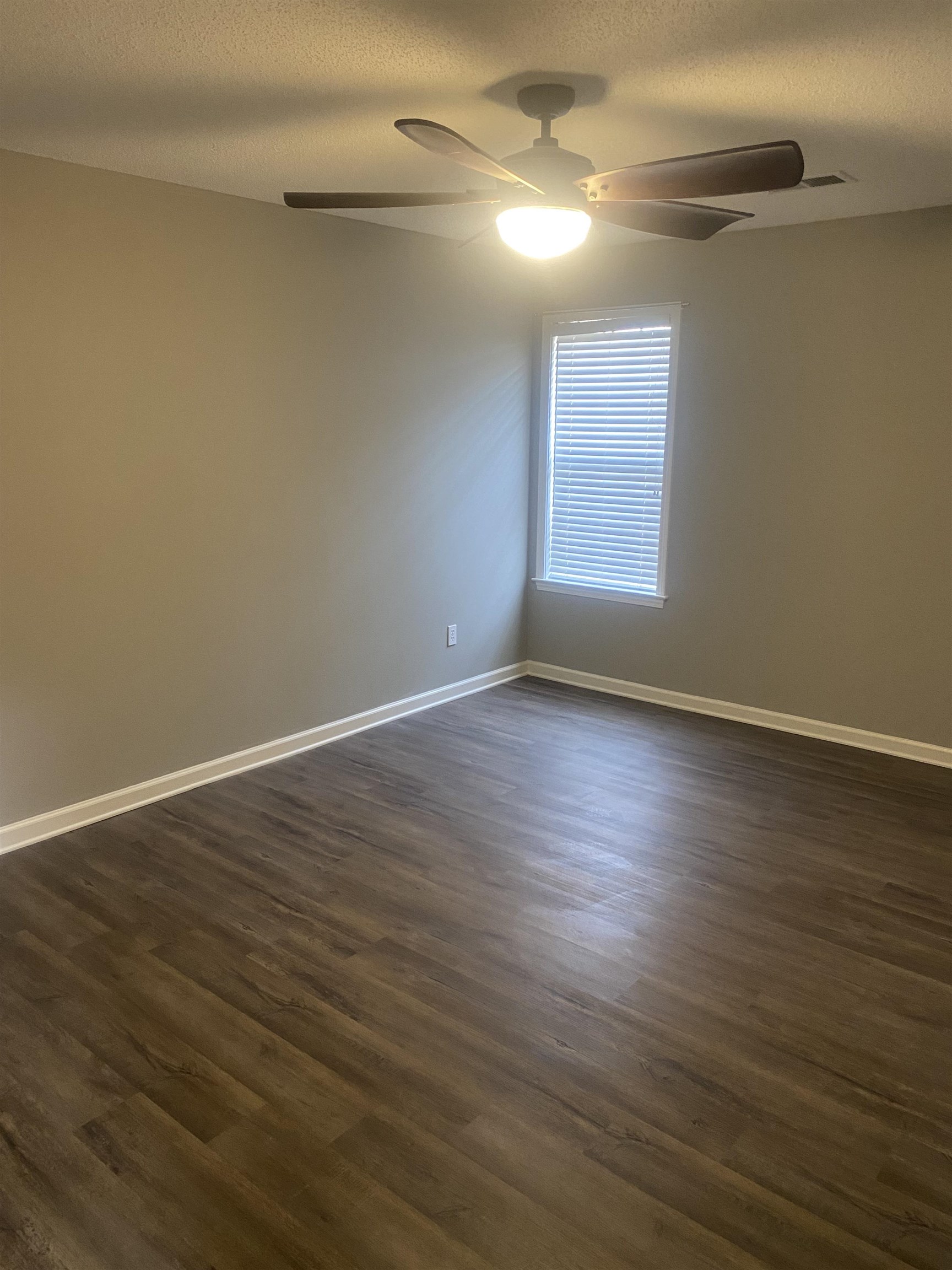 1167 Junco Cove Collierville, TN 38017 - Photo 19 of 25 a view of an empty room with wooden floor and a window