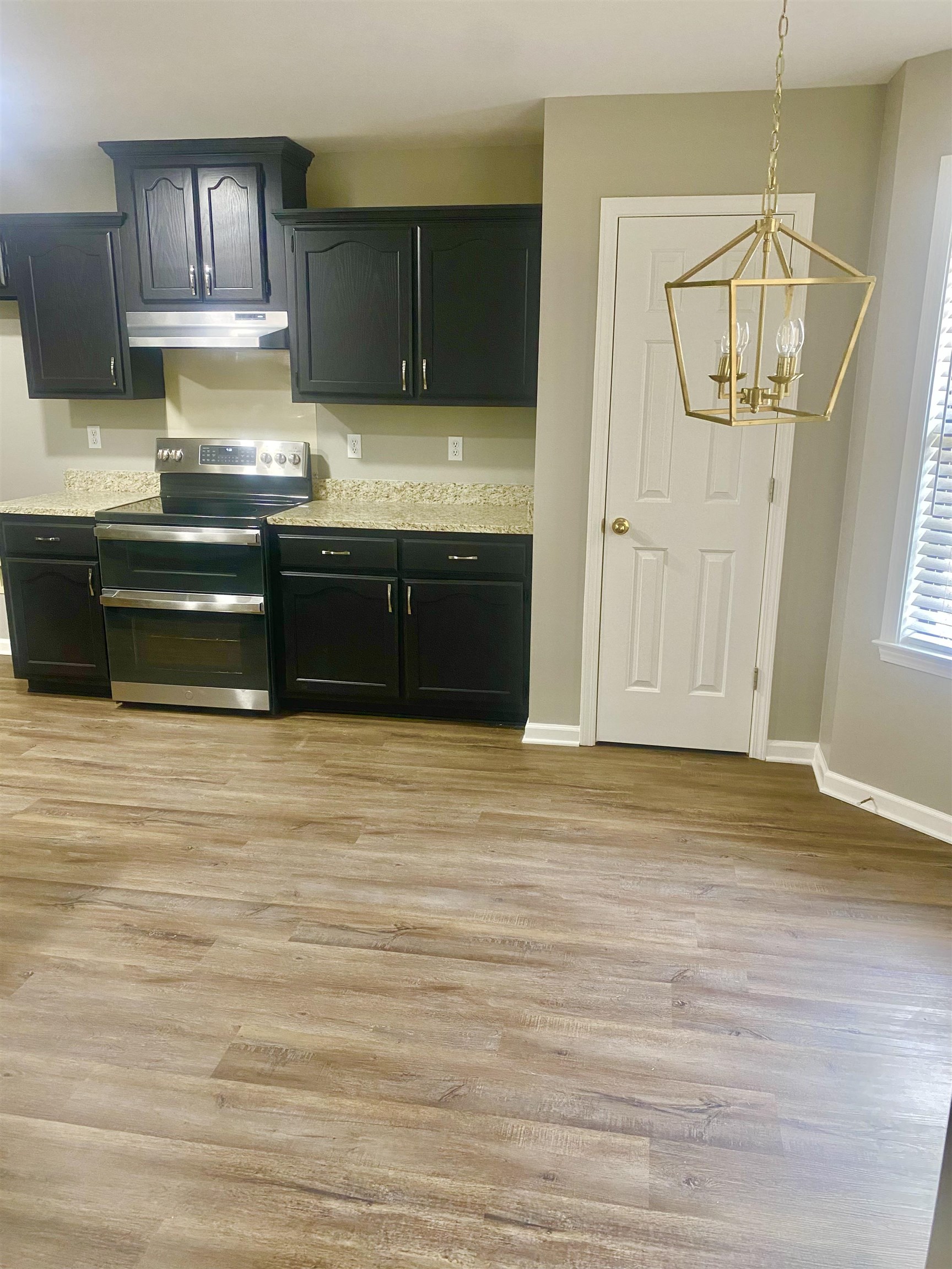 1167 Junco Cove Collierville, TN 38017 - Photo 9 of 25 a kitchen with stainless steel appliances granite countertop a stove a sink and a refrigerator