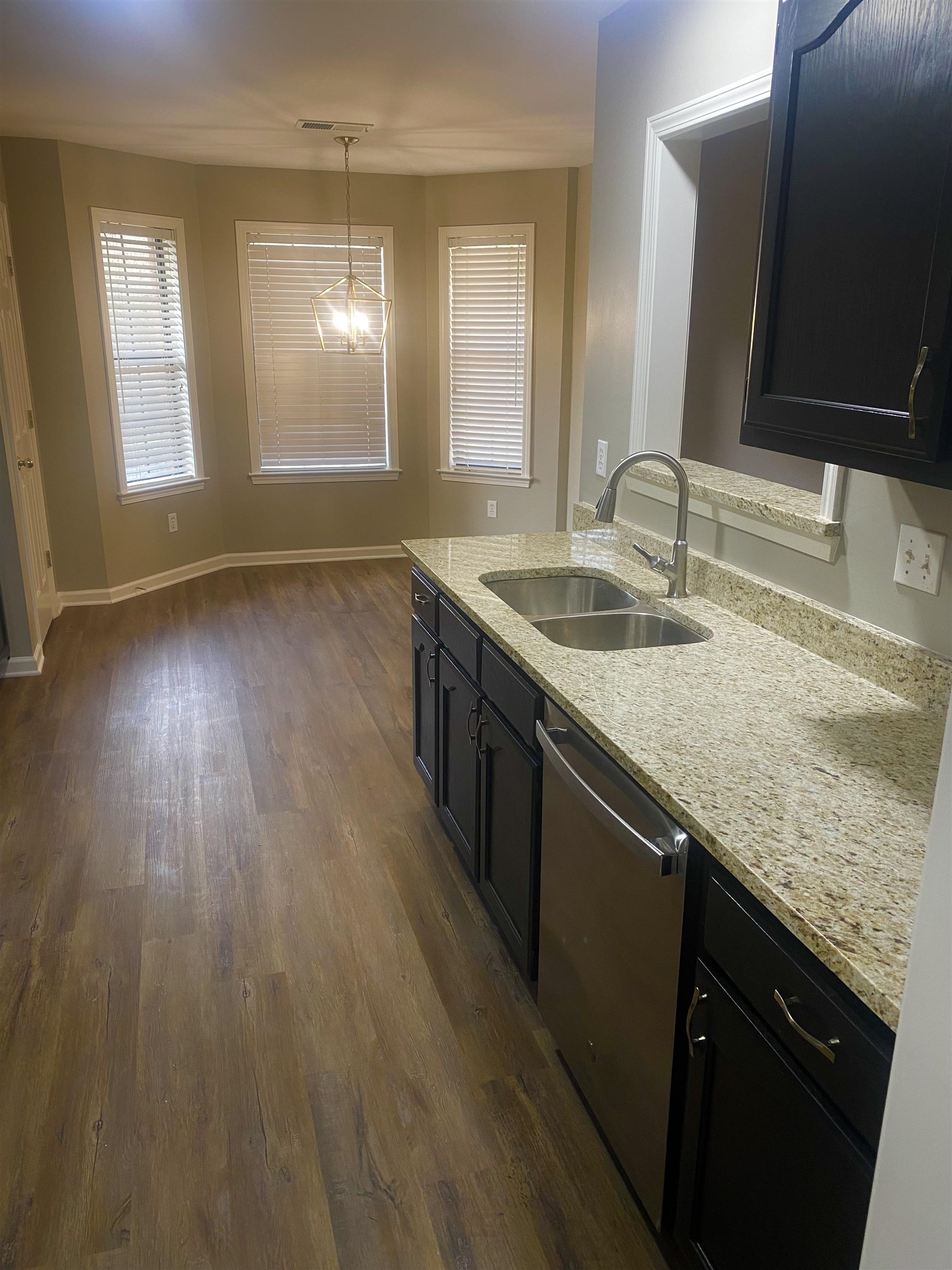 1167 Junco Cove Collierville, TN 38017 - Photo 10 of 25 a kitchen with granite countertop a sink and a wooden floor