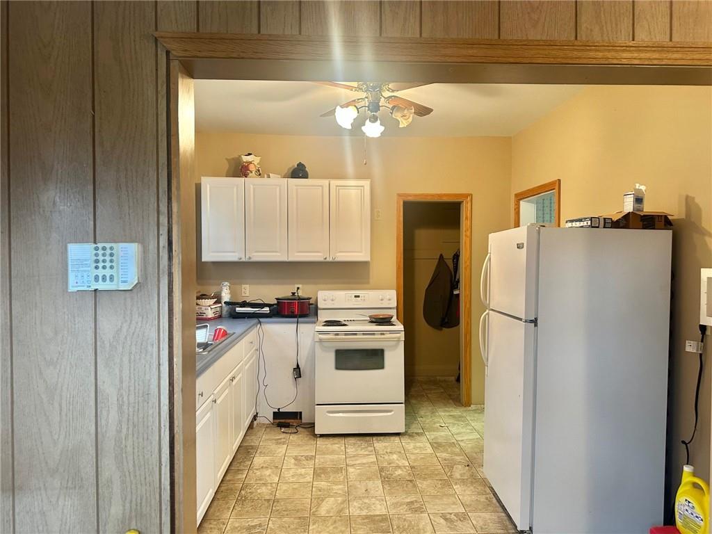 320 Reis Street New Castle, PA 16101 - Photo 8 of 18 a kitchen with a refrigerator sink and cabinets