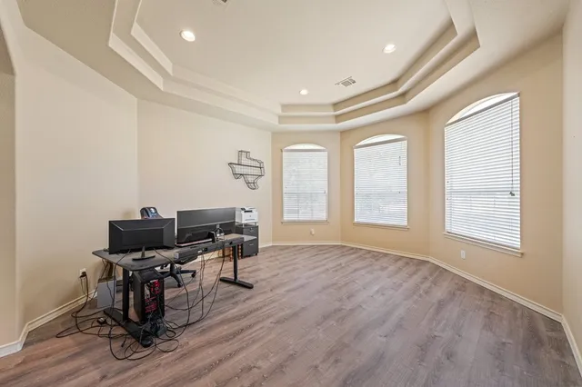 a view of a workspace with furniture and a window