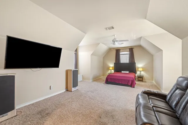 a hallway with a couches and a flat screen tv