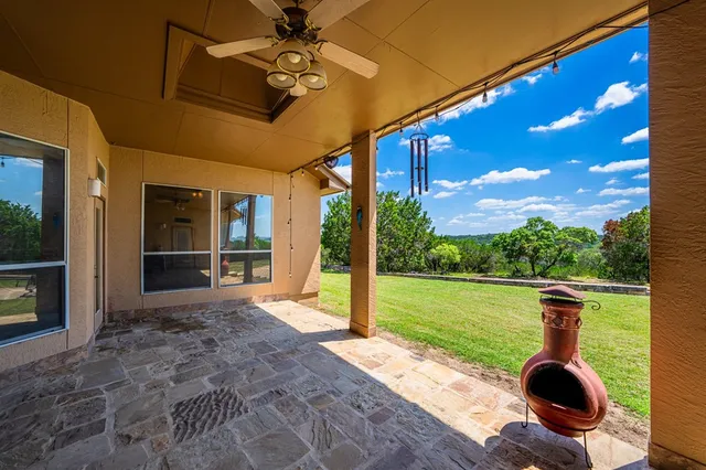 a view of a porch with furniture and yard