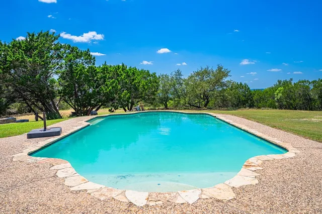 a view of a swimming pool with an outdoor space and seating area