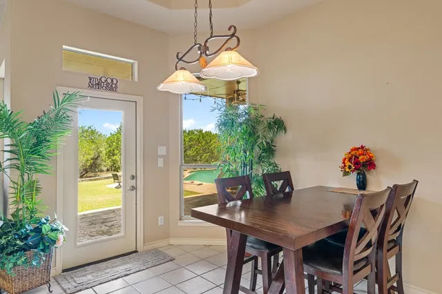a view of a dining room with a table and chairs