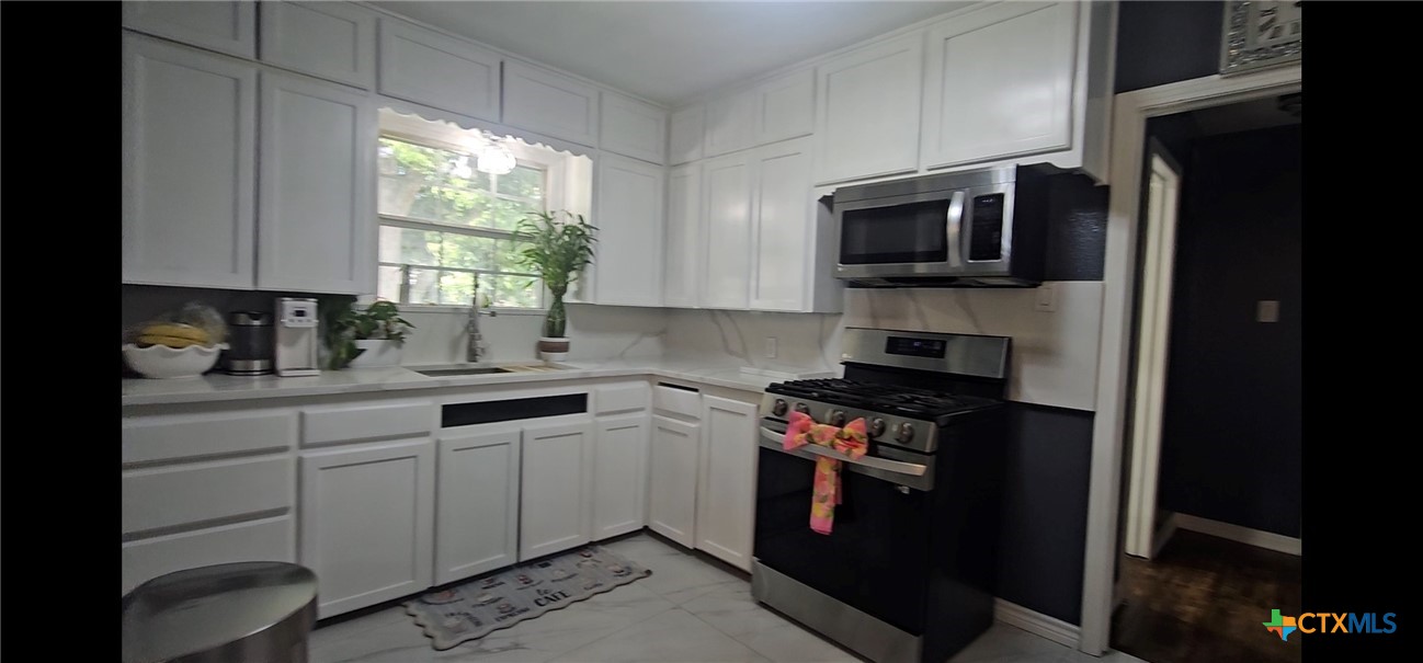 1901 South 33rd Street Temple, TX 76504 - Photo 17 of 20 All new Kitchen Cabinet doors. New Microwave and New Gas stove conveys with reasonable offer. Nice pantry. Porcelain Tile Floors.
