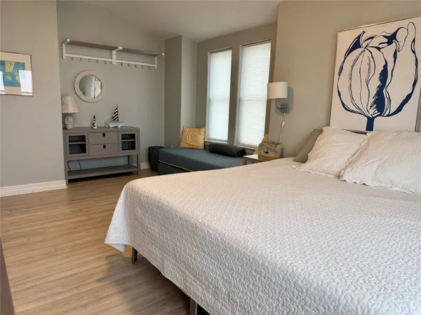 a bedroom with a bed a mirror and a window