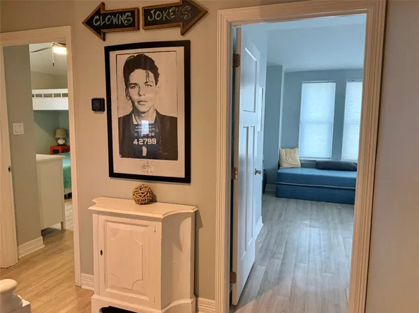 a view of a hallway with wooden floor and closet