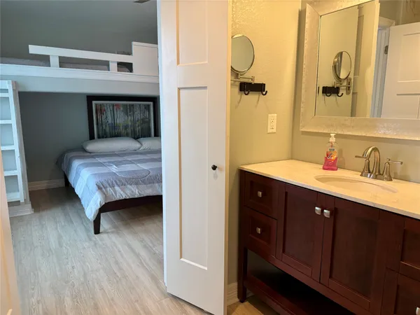 a en suite bathroom with a sink double vanity and a mirror