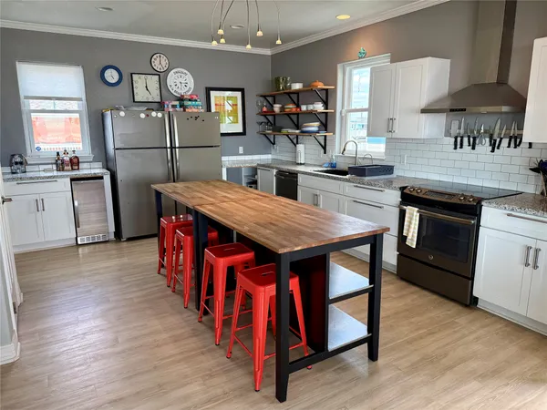 a kitchen with stainless steel appliances granite countertop a stove refrigerator and cabinets