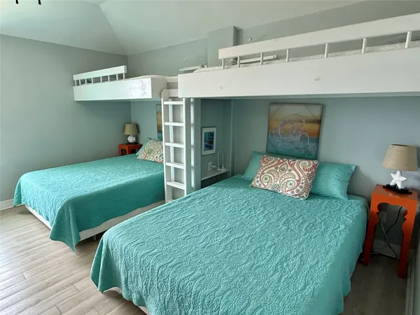 a bedroom with two beds and a lamp
