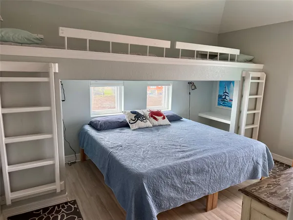 a bedroom with bed and a window