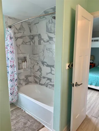 a bathroom with a bathtub and shower