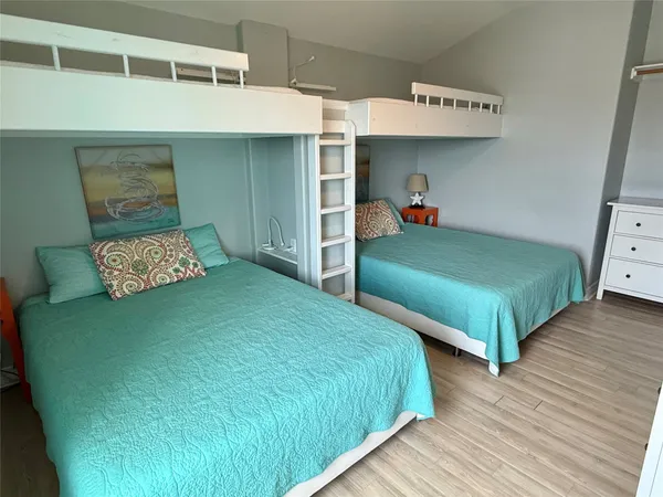 a bedroom with two beds and a dresser