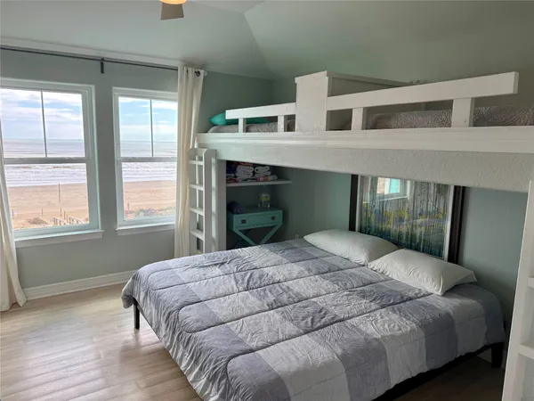 a bedroom with a large bed and a window