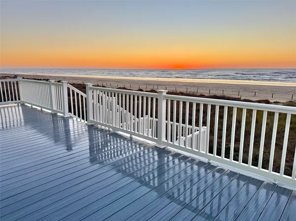 a view of balcony with wooden floor and fence