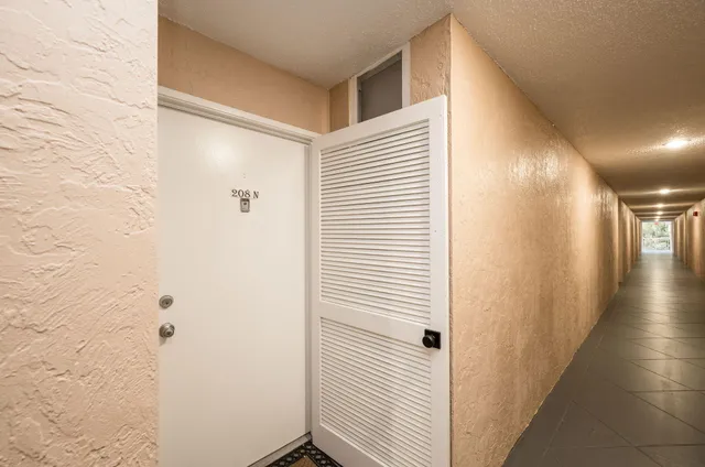 a view of a house with a swimming pool and sitting area