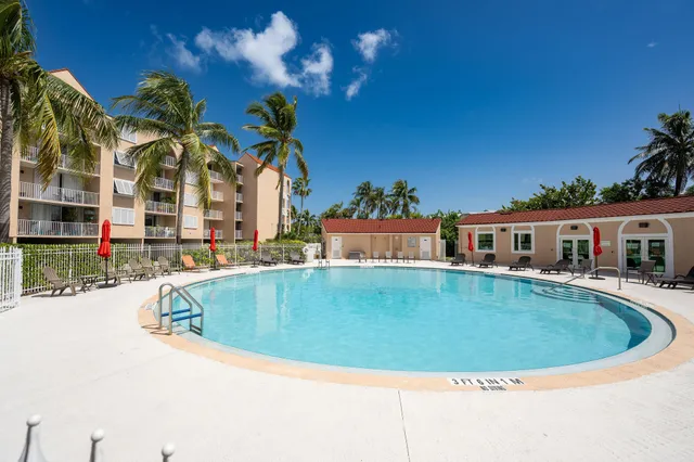 a front view of a house with yard and swimming pool