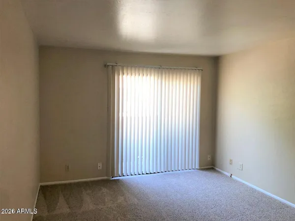 a view of a room with an empty space and window