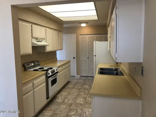a kitchen with stainless steel appliances a stove a refrigerator and cabinets
