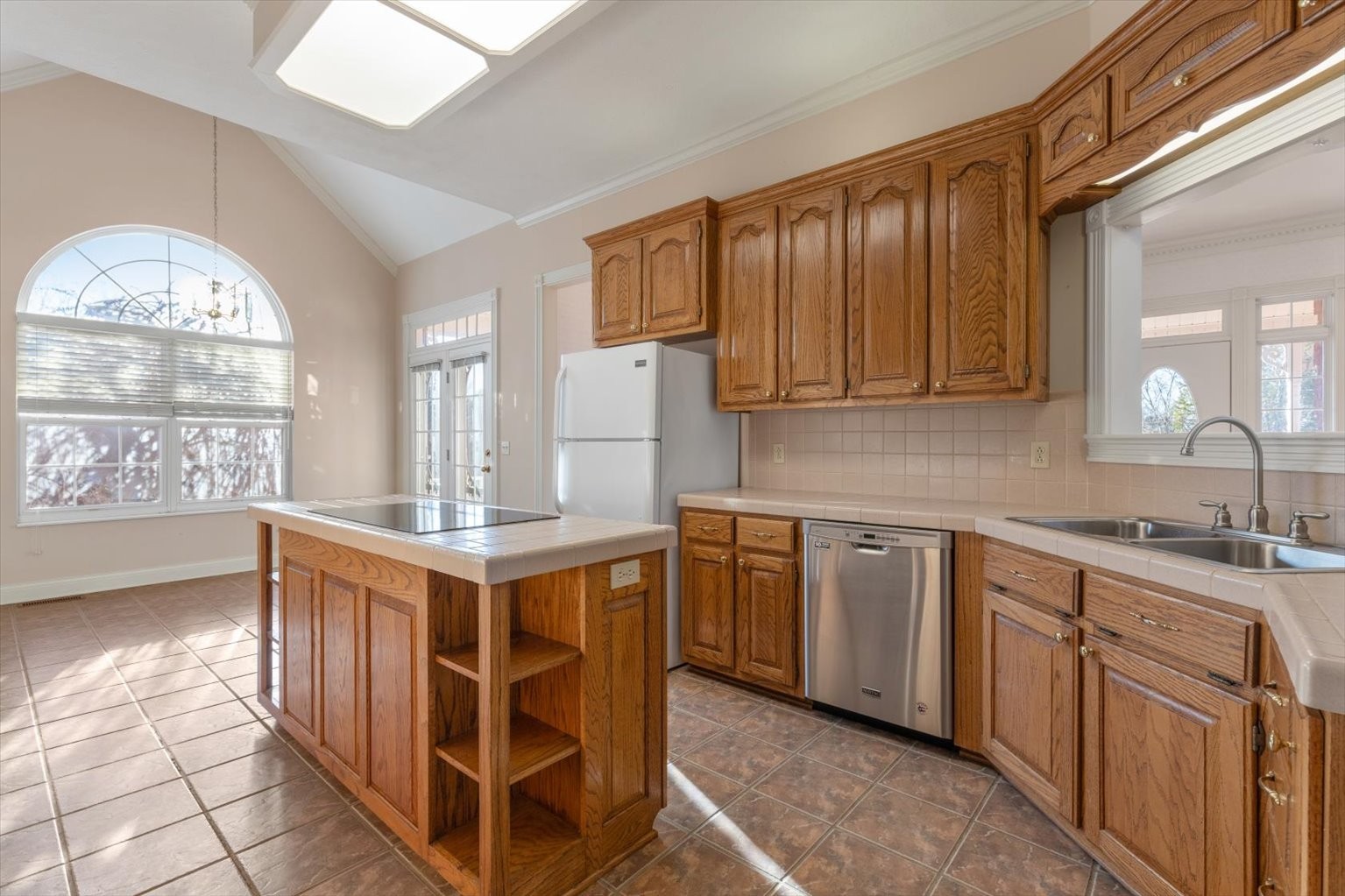 3160 Tom Holt Road Clifton, TN 38425 - Photo 16 of 53 a kitchen with stainless steel appliances granite countertop a stove a sink dishwasher and cabinets with wooden floor